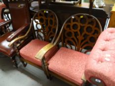 A pair of vintage fretwork wood back cushion sprung armchairs