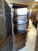An Ercol standing corner cupboard with open top shelves & cupboard base