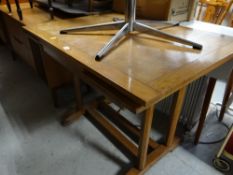 A vintage light oak pullout extending dining table