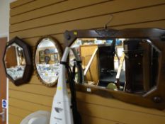 Two vintage oak framed bevelled glass wall mirrors together with a similar vintage bevelled glass