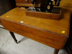 A lightwood Pembroke table with drawers to either end