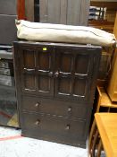 A vintage dark oak cupboard & drawer combination together with a vintage military camp bed