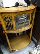 An integrated hi-fi system including CD player, record deck etc housed in an elaborate shaped top