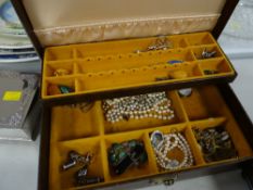 A jewellery box containing quantity of costume jewellery, semi-precious stones, badges etc