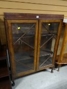 A vintage dark wood Deco-style two glass door display cabinet