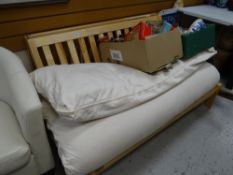 A pine folding futon / bed settee with cushion / mattress
