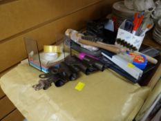 A tray of various desk equipment including punches, pen holders etc