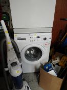 A Bosch Varioperfect washing machine in white together with an Electrolux upright vacuum cleaner E/