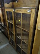 A good vintage oak two glass door bookcase with railback shelf top