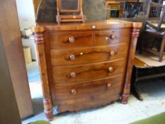 A Victorian mahogany bow fronted chest of drawers, two short above three long, with column supports