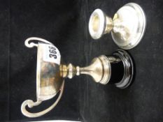 Silver twin handled trophy cup and a single squat candlestick