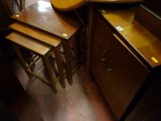 Two door cupboard and a nest of three mahogany coffee tables
