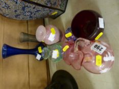 Cranberry glass jug with Mary Gregory style decoration and seven other items of colourful glassware