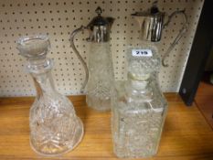 Two decanters with stoppers and two claret jugs