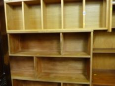 Modern narrow light oak effect bookcase and a multi-shelved mid Century bookcase
