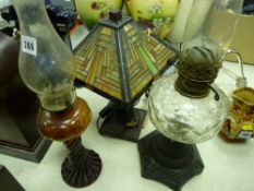 Iron based oil lamp, glass based oil lamp and a Tiffany style table lamp