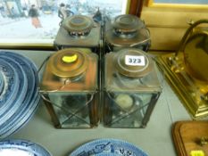 Four copper effect tea light lamps