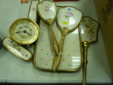 Five piece dressing table set on a tray and a near matching clock
