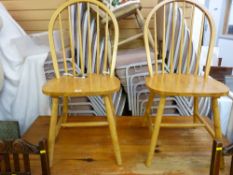 Modern rectangular topped pine table and two spindlebacked chairs