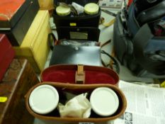 Three cased sets of binoculars