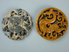 TWO CHINESE CARVED JADE ROUNDELS, one showing a mythical beast, 6.75 cms diameter, the other