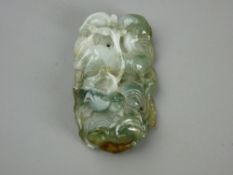 A 6 cms CARVED JADE PENDANT depicting a mythical beast amongst waves