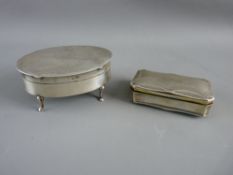 AN OVAL SILVER DRESSING TABLE BOX and a rectangular silver snuff box, satin lined interior on four
