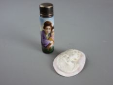 A CERAMIC SCENT BOTTLE with silver lid and an unmounted carved pink cameo oval, the scent bottle