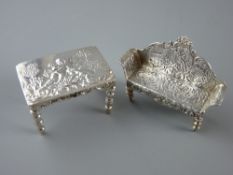 A MINIATURE SILVER TABLE & SALON COUCH, the tabletop with cherubic decoration, London 1898, the