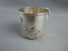 A CHESTER SILVER CHILD'S CHRISTENING MUG with embossed decoration of a youngster feeding chickens,