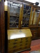 A LATE GEORGIAN MAHOGANY BUREAU BOOKCASE, the top cornice with Greek Key decoration over twin