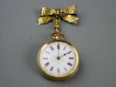 A FIFTEEN CARAT GOLD CASED LADY'S FOB WATCH with ribbon bow pin, gilt highlighted white enamel dial,