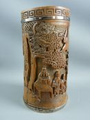 A CIRCA 1900 BAMBOO BRUSH POT, carved to depict scholars in a woodland setting, the upper rim with