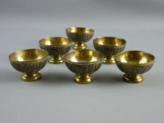 SIX PERSIAN STYLE PEDESTAL SALTS in brass with copper banding and silver Cyrillic script inlaid,