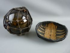 AN AMBER GLASS FISHING NET FLOAT complete with rope and a model of a coracle