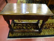 A REPRODUCTION JOINED OAK FOOTSTOOL with moulded edge rectangular top and carved frieze detail, on