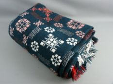 A TRADITIONAL WELSH WOOLLEN BLANKET with 'Holytex' label, in dark green with red and white woven