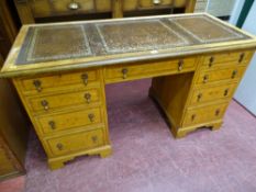 A BURR WALNUT TWIN PEDESTAL DESK, the crossbanded walnut top with three section gilt tooled skiver