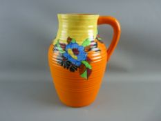 A CIRCA 1920 SINGLE HANDLE LOTUS 'INDIAN SUMMER' JUG, 29 cms high with ribbed body having a