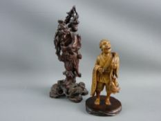TWO JAPANESE CARVED FIGURINES of a fruit gatherer and a carp fisherman, 19.5 and 13.5 cms high