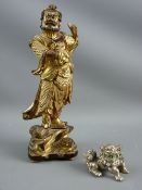 AN ORIENTAL CARVED WOOD FIGURE and a white metal Temple Lion, the figure possibly a bearded actor,