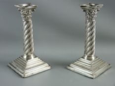 A PAIR OF SILVER CANDLESTICKS, London 1895 (loaded) with Corinthian caps and removable sconces, on
