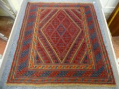 AN EASTERN TRIBAL CAZAK RUG, green and blue ground with diamond centre and triple bordered edge, 137