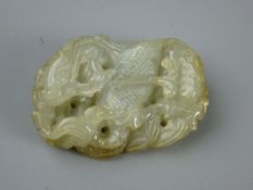 A 5 cms CARVED JADE PENDANT depicting a mythical beast amongst waves