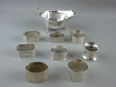 A SILVER SAUCE BOAT, Birmingham 1910 by Mappin & Webb and eight individual napkin rings, various