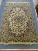 AN ISFAHAN WOOL RUG, with three row border and a fawn ground centre with blue and red floral and