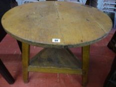 AN ANTIQUE PINE CRICKET TABLE, the 70 cms diameter top on a standard peg-jointed frame with