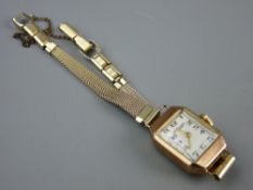 A NINE CARAT GOLD OBLONG DIAL LADY'S WRISTWATCH with tapered style yellow metal bracelet, 2.2 grms