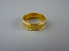 A TWENTY TWO CARAT GOLD WIDE WEDDING BAND, 7.3 grms