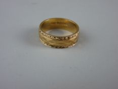 A NINE CARAT GOLD WIDE WEDDING BAND with diamond and feather edging pattern, 3.5 grms